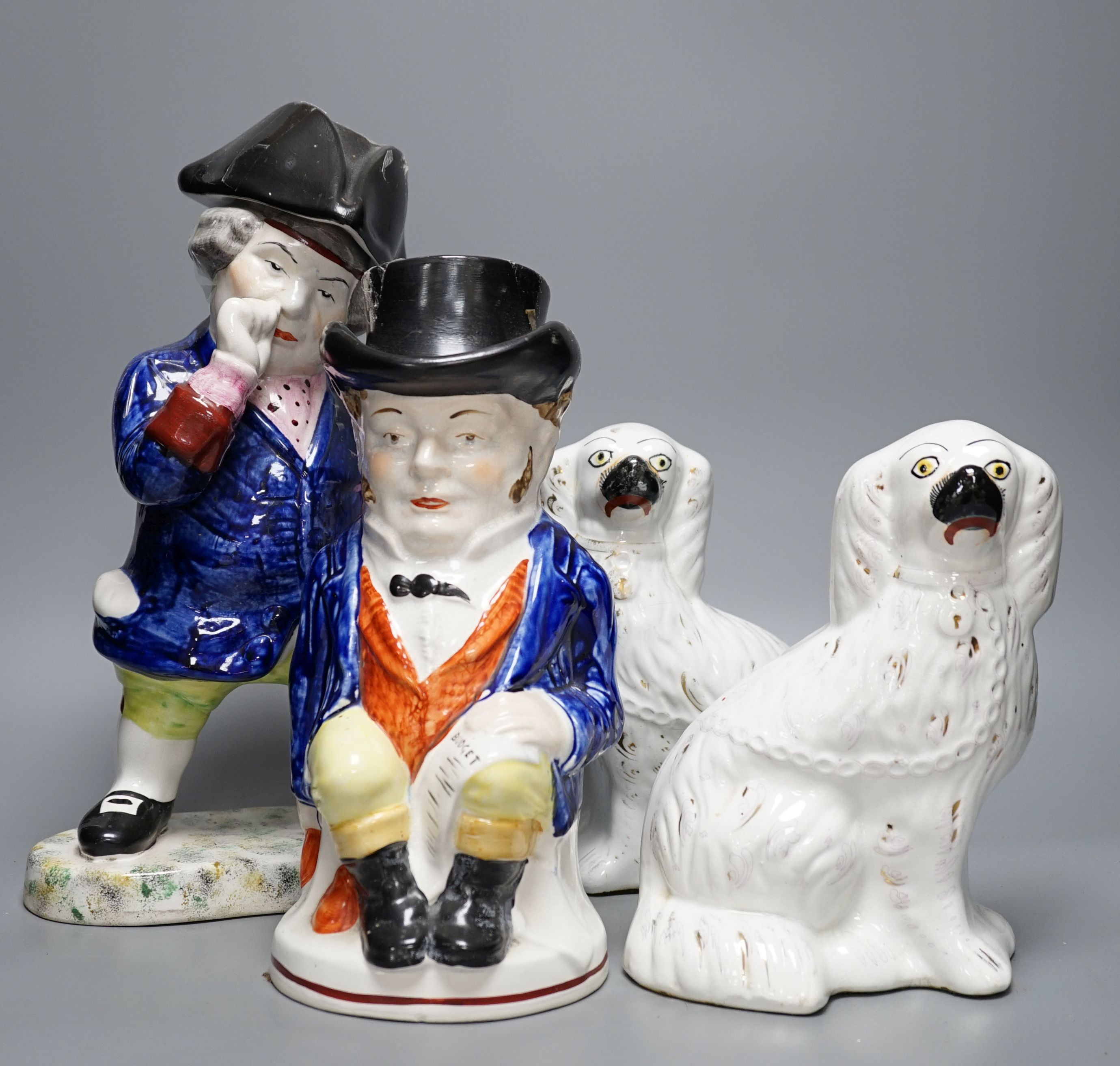 Two Staffordshire Toby jugs and a pair of Kings Charles Spaniel figures